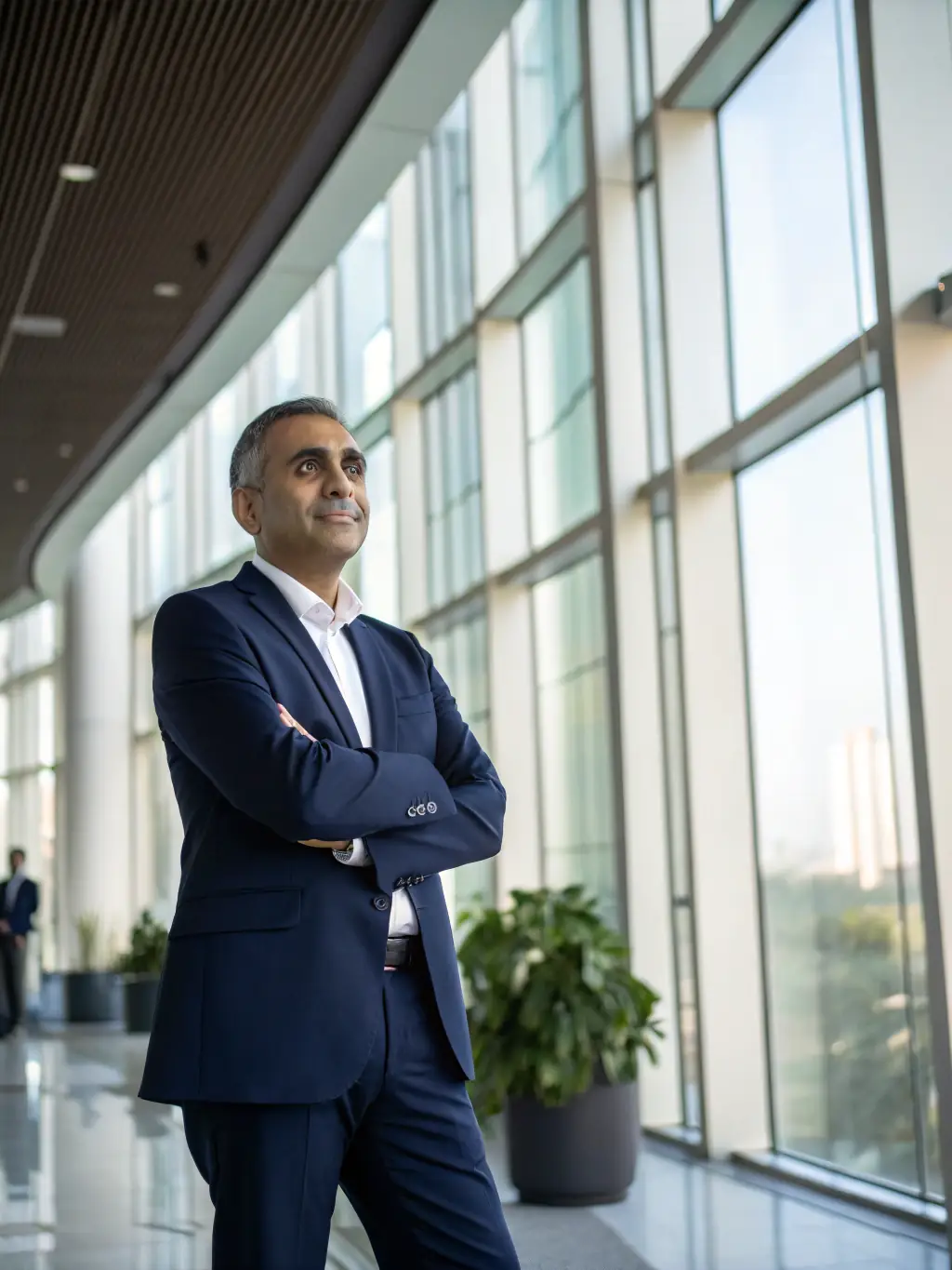 A professional Indian businessman in a modern office, confidently presenting a growth strategy on a digital tablet, showcasing business coaching in action.